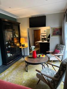 a living room with a table and chairs and a kitchen at Greyton Stay in Greyton