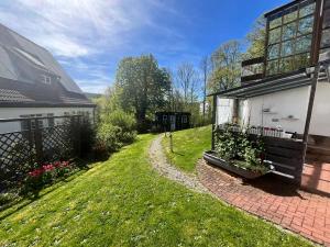 a backyard of a house with a grass yard at Ferienwohnung Rhöner Luft in Bad Brückenau