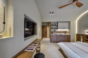 a bedroom with a large bed and a kitchen at DOMUS GEORGiO in Litochoro