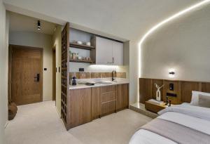 a bedroom with a bed and a sink and a kitchen at DOMUS GEORGiO in Litochoro +10 photos