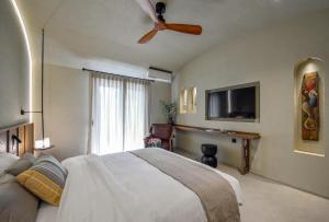 a bedroom with a bed and a ceiling fan at DOMUS GEORGiO in Litochoro