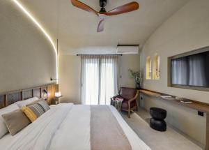 a bedroom with a large bed with a ceiling fan at DOMUS GEORGiO in Litochoro