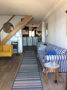a living room with a couch and a table at La maison bleue in Bouzigues