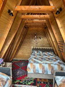 a bedroom with a bed in a wooden attic at Vila Prevoja in Nova Varoš