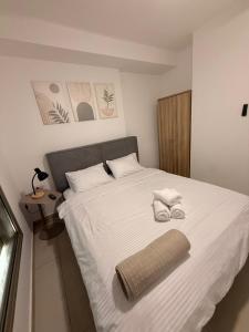 a bedroom with a bed with two towels on it at Sunset suite - step from the beach in Ashkelon +31 photos