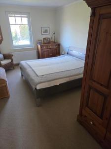 a bedroom with a large bed and a window at Ferienhaus mit Naturblick in Putbus