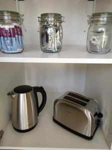 a toaster and a toaster sitting on a shelf at Calme et Volupté in Maxilly-sur-Saône +6 photos