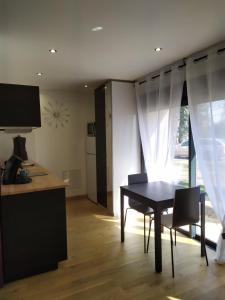 a kitchen and dining room with a table and chairs at Calme et Volupté in Maxilly-sur-Saône