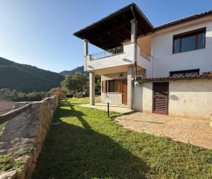 a large white house with a fence and a yard at Villa Olbia mare in Olbia +33 photos
