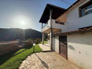 a white house with a door and a yard at Villa Olbia mare in Olbia