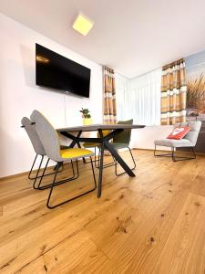 a dining room with a table and two chairs at Beach SUN and FUN in Podersdorf am See