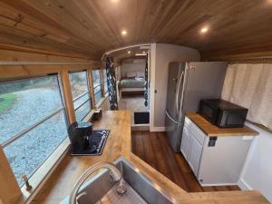 an interior view of a kitchen in a tiny house at Lazy T Cabins - The Skoolie in Robbinsville