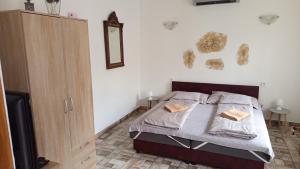 a bedroom with a bed with two pillows on it at BORINA VENDÉGHÁZ in Sátoraljaújhely