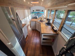an interior view of a kitchen in an rv at Lazy T Cabins - The Skoolie in Robbinsville