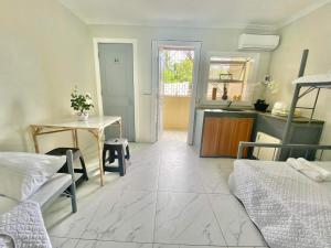 a living room with a table and a bed at Nol's Inn in Iloilo City +4 photos