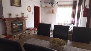 a living room with a table and a fireplace at BORINA VENDÉGHÁZ in Sátoraljaújhely