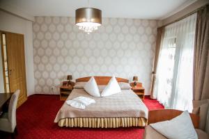 a bedroom with a bed with two towels on it at Hotel Oaza in Prudnik +18 photos
