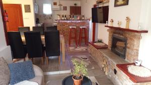 a living room with a table and a fireplace at BORINA VENDÉGHÁZ in Sátoraljaújhely