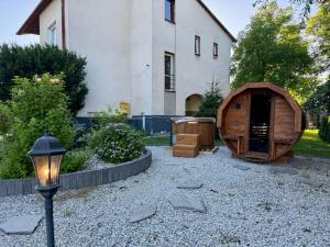 a backyard with a wooden house and a street light at Apartamenty Podlesie in Przeciszów