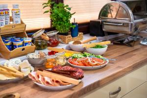 a buffet with different types of food on a counter at Beskid Balans & SPA in Krynica Zdrój
