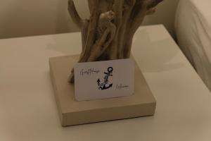 a vase with a tree with a sign on it at L'Ancora in Rapallo