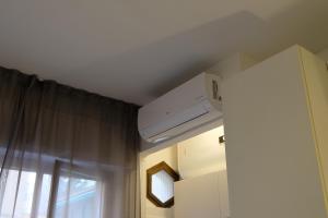 a room with a ceiling fan and a window at L'Ancora in Rapallo +7 photos