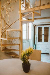 a spiral staircase in a room with a table at Loft Raffaello 22 in Urbino