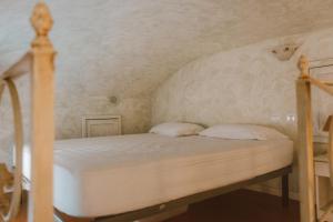 a bedroom with a bed with a white headboard at Loft Raffaello 22 in Urbino