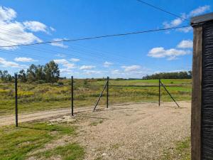 a group of metal poles in a field at Refugio del Horizonte Colonia in Colonia del Sacramento
