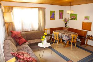 a living room with a couch and a table at B&B St Moritz in St. Moritz