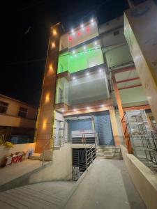 a building with a gate in front of it at night at RASHI Lodge Attibale in Attibele