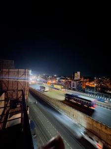 a city at night with a train on a highway at RASHI Lodge Attibale in Attibele +12 photos