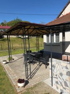 a pavilion with a table and chairs on a patio at Vikendica Lazic in Crnča
