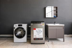a washing machine and a sink in a room at After Hours Guesthouse Self Check-in in Bangkok +23 photos