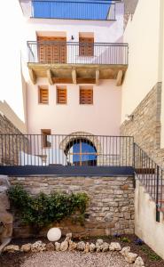 an external view of a building with a balcony at Ca la Bepa in Rocafort de Vallbona