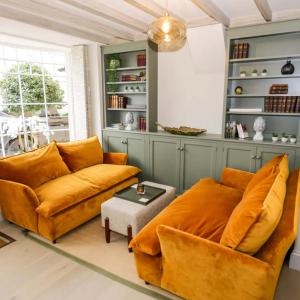 a living room with a couch and a table at Bay House in Broadway
