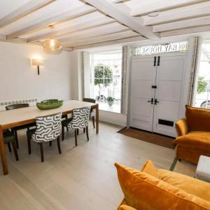 a living room with a table and chairs and a door at Bay House in Broadway