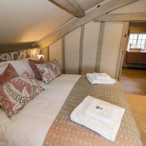 a bed with two towels on top of it at Bay House in Broadway
