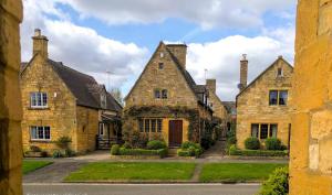 a group of stone houses with a driveway at Bay House in Broadway