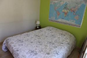 a bedroom with a bed and a map on the wall at Chambre, entrée indépendante, SDB privée in Cugand