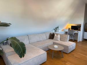 a living room with a couch and a table at Wohnung Dorfblick in Hauenstein