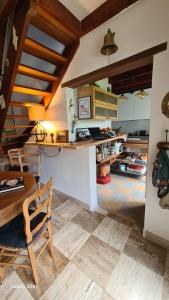 a kitchen with a table and a chair and a desk at le moulin in Pont-Croix
