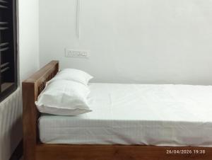 a bed with white sheets and pillows on it at Nature Heritage by Marari in Mararikulam +10 photos