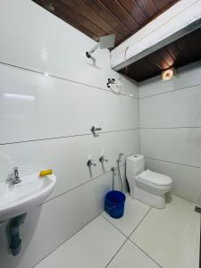 a white bathroom with a sink and a toilet at Nature Heritage by Marari in Mararikulam
