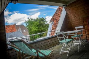 a balcony with chairs and a table and a window at Hotel Nieuwe Markt in Deventer