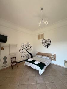 a bedroom with a bed and a chandelier on the wall at La Petra in Vico Equense