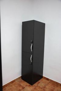 a black cabinet in the corner of a room at Berat Hill Hostel in Berat +20 photos