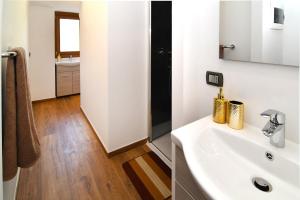 a bathroom with a white sink and a mirror at CáMillina in Santa Maria Maggiore