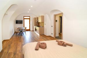 a bedroom with a bed with two brown towels on it at CáMillina in Santa Maria Maggiore