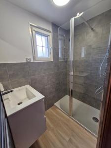 a bathroom with a shower and a sink and a tub at Gîte au coeur du pays dinannais in Plumaudan